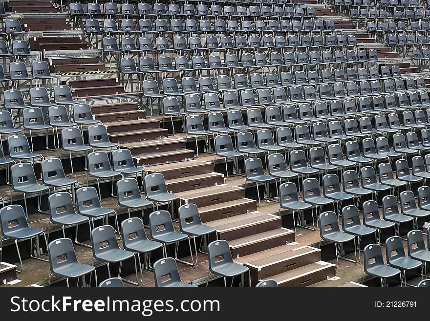 Plenty of grey seats arranged on temporary concert hall. Plenty of grey seats arranged on temporary concert hall