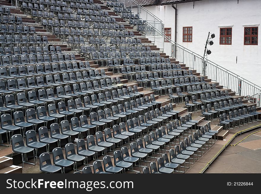 Plenty of grey seats arranged on temporary hall. Plenty of grey seats arranged on temporary hall