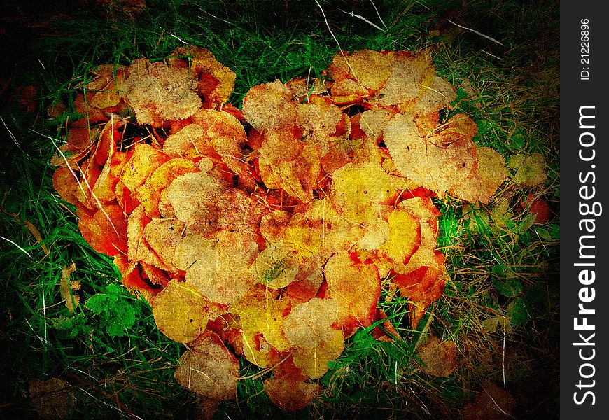 Grunge background with heart shaped autumn leaves.