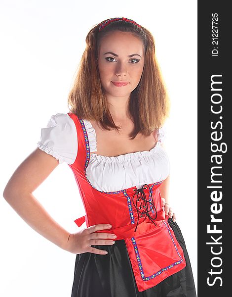 The girl in a traditional Bavarian dress with full glasses of beer in hands