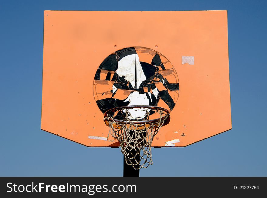 Orange and grunge basketball backboard and sky background