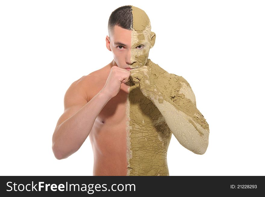 Young man half smeared with clay