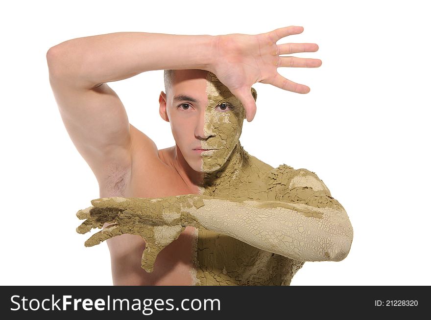 Young man half smeared with clay