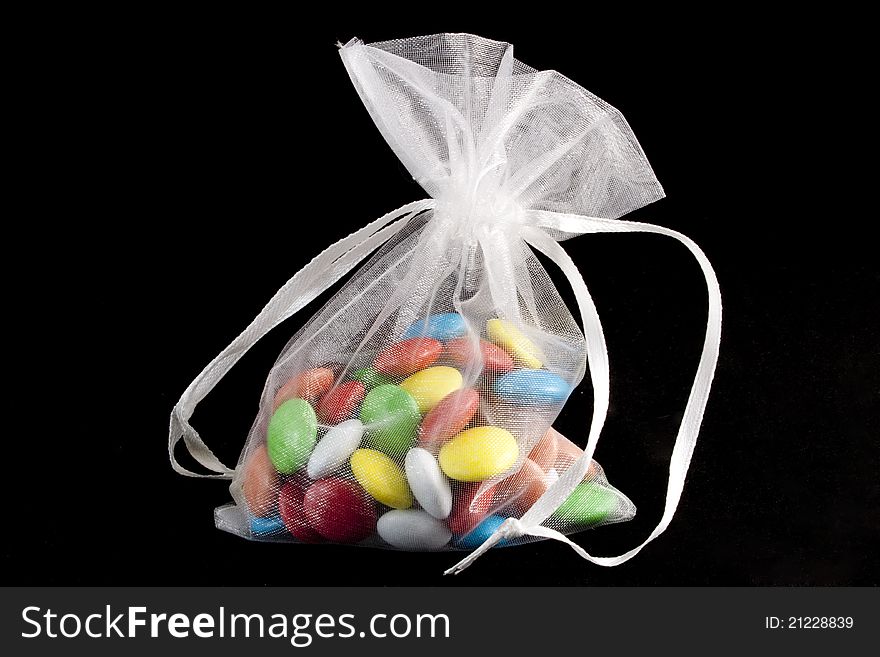 Colorful jawbreakers in white saccule. Colorful jawbreakers in white saccule