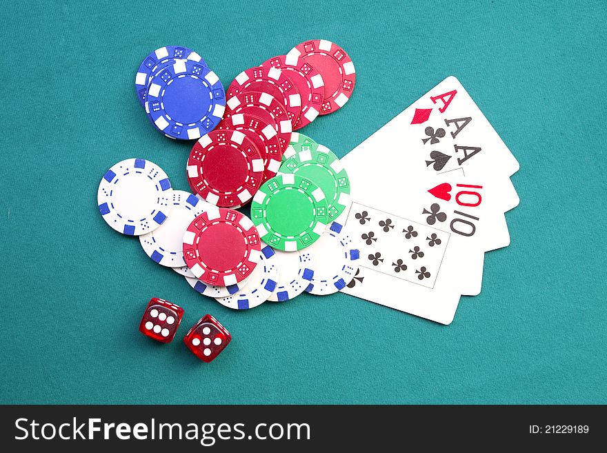 Dice, poker chip and playing cards on green background. Dice, poker chip and playing cards on green background