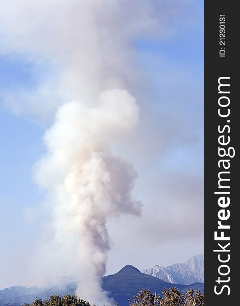 Smoke from a fire in the mountains of italian north