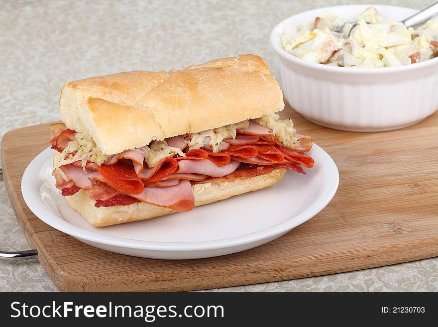 Ham, pepperoni and bacon sandwich on a plate