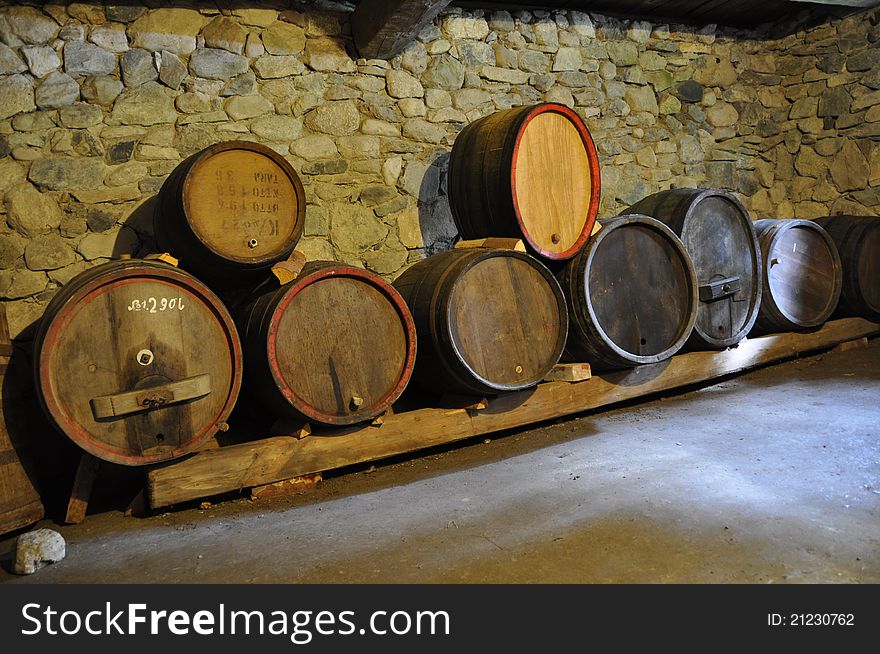 Row of wooden barrels in a basement