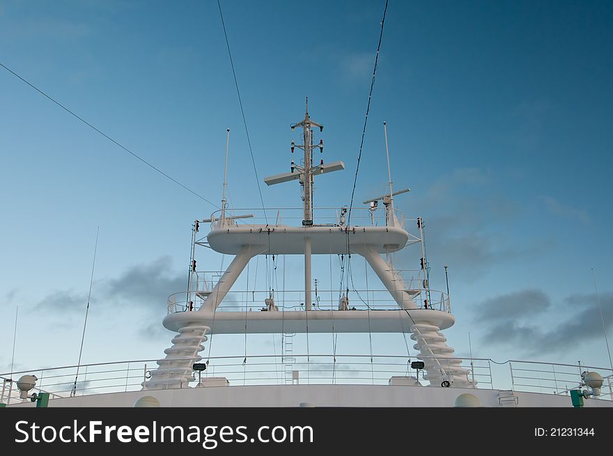 Radar and communications equipment on cruise ship with blue sky.