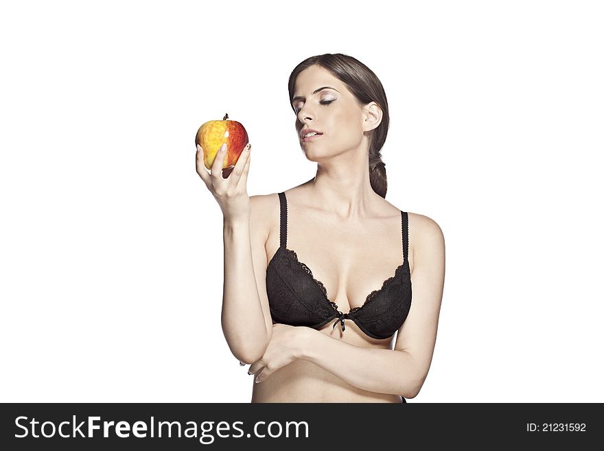 Beautiful woman is looking down at a big yellow and red apple. She is naked and has her hair in a ponytail. Beautiful woman is looking down at a big yellow and red apple. She is naked and has her hair in a ponytail.