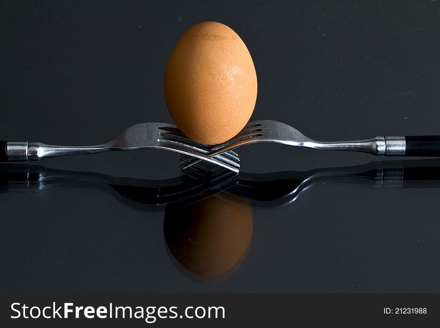 Egg on the bottom supported by two forks