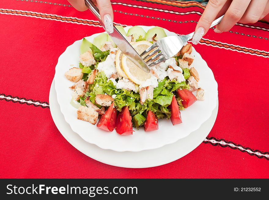 Girl in a restaurant eating Caesar salad. Girl in a restaurant eating Caesar salad