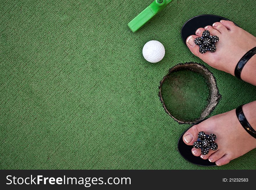 Golf ball and green grass as background