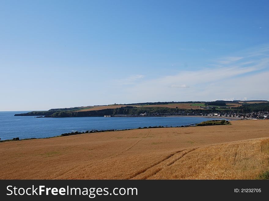 A view across farmland to the coastline of Stonehaven in Scotland. A view across farmland to the coastline of Stonehaven in Scotland