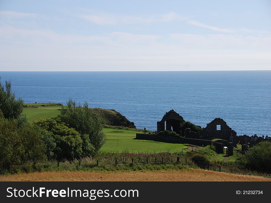 A view across farmland to a ruined church near Stonehaven in Scotland. A view across farmland to a ruined church near Stonehaven in Scotland