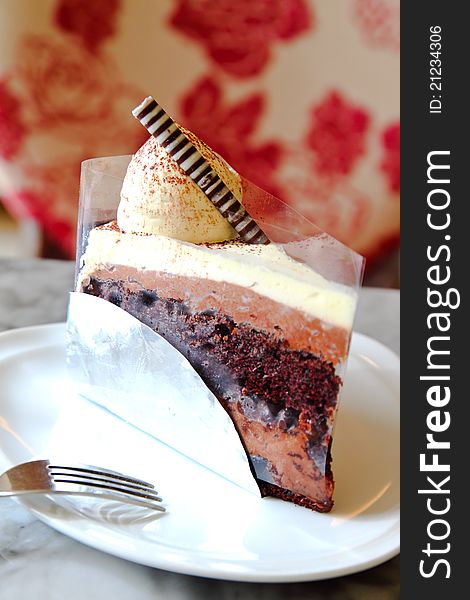 Yummy chocolate cake with fork on white plate