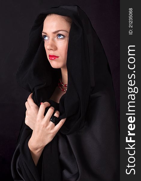 Young nun with blue eyes and red lips