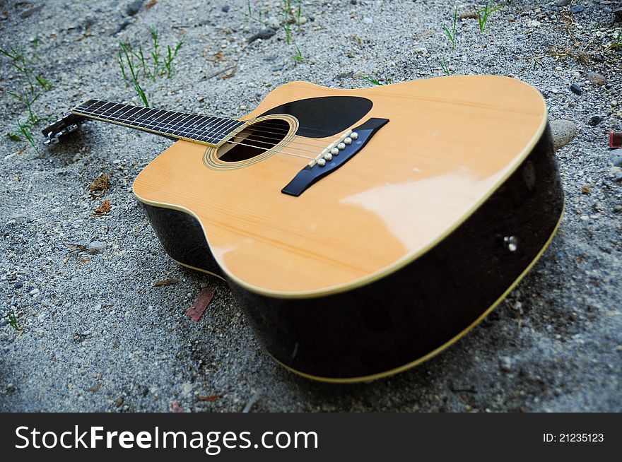 Picture of guitar lying on the sand. Picture of guitar lying on the sand