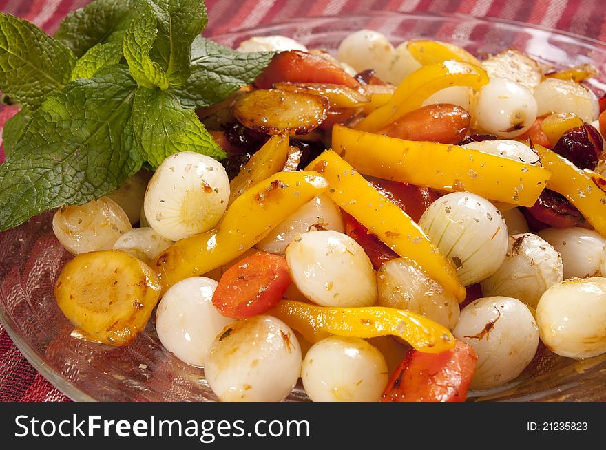 Colorful roasted onions peppers and carrots in a glass dish. Colorful roasted onions peppers and carrots in a glass dish