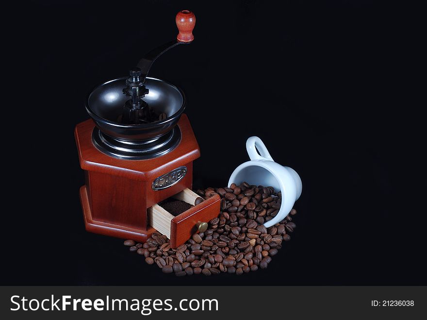 Coffee wooden grinder  and beans and white  cup