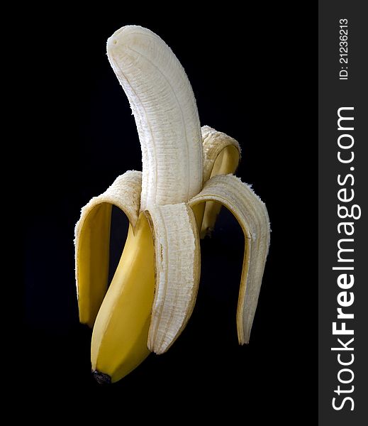 Peeled banana on a dark background