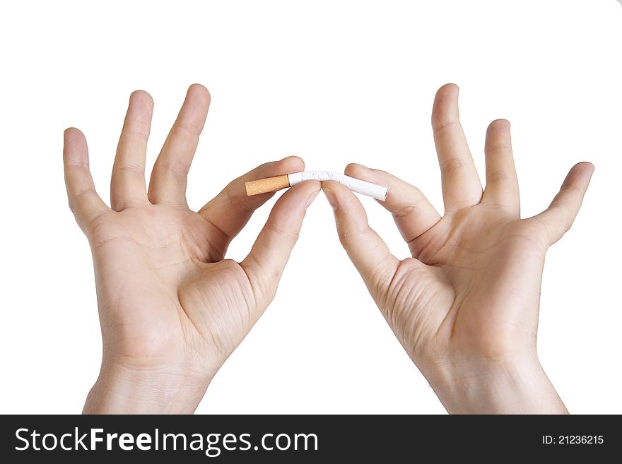Man's hands breaking a cigarette on isolated background