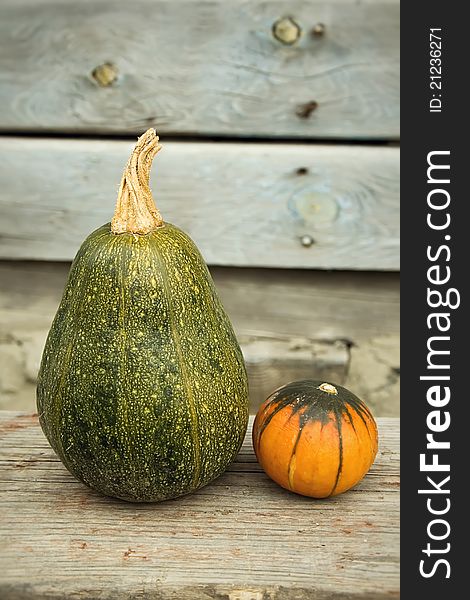 The three bright pumpkins on a wooden bench. The three bright pumpkins on a wooden bench