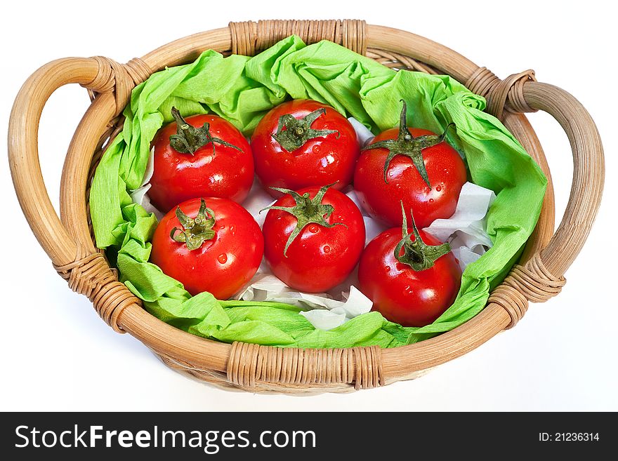Red ripe tomatoes in the woven basket