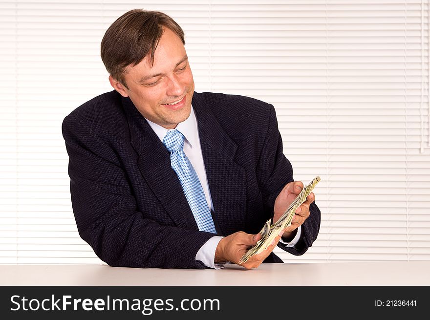 Portrait of a businessman with cash at office. Portrait of a businessman with cash at office