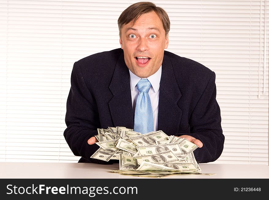 Portrait of a businessman with cash at office. Portrait of a businessman with cash at office