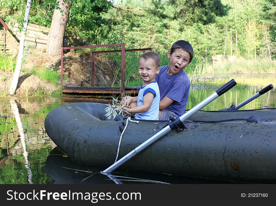 Little Boys Boating in lake