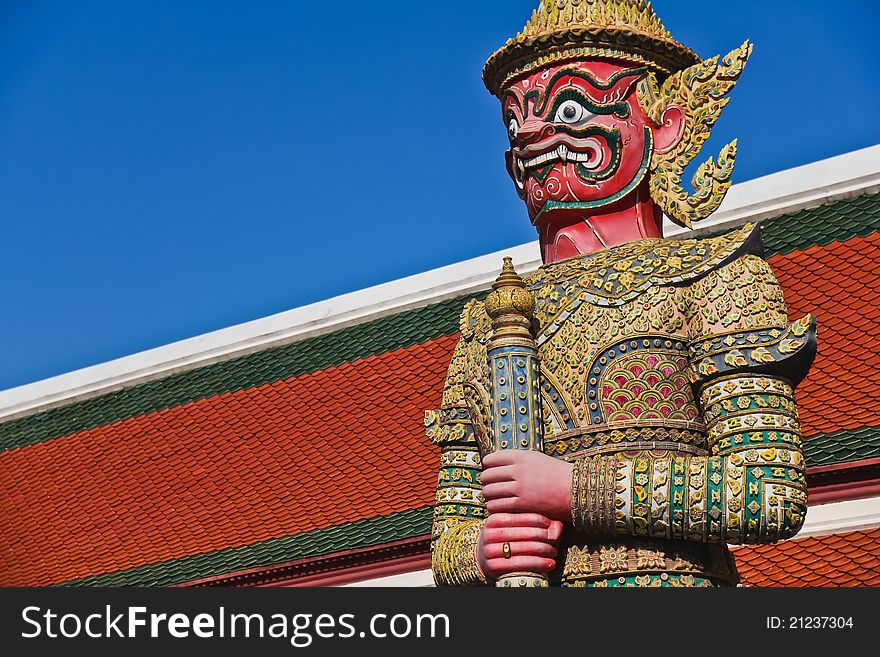 Red demon gate guardian at Wat Pra Kaew, named Suriyaphop. Red demon gate guardian at Wat Pra Kaew, named Suriyaphop
