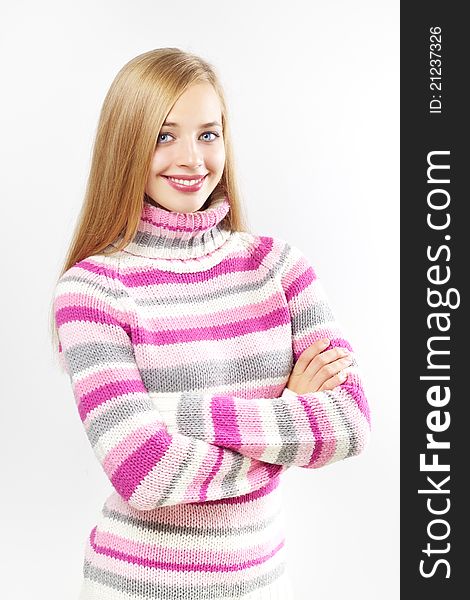 Portrait of pretty girl wearing sweater on a light background. Portrait of pretty girl wearing sweater on a light background