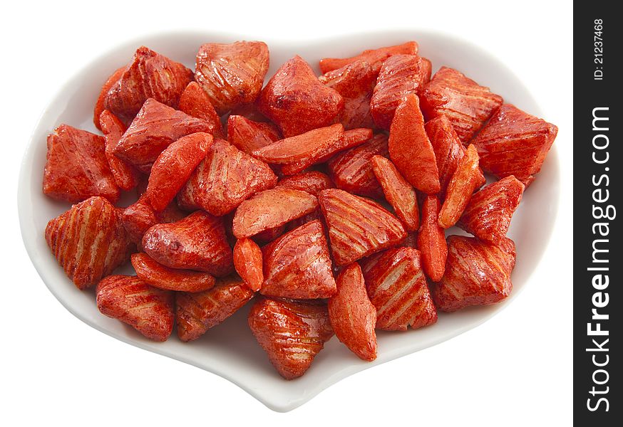 Red cookies on the heart-shaped saucer isolated on the white background