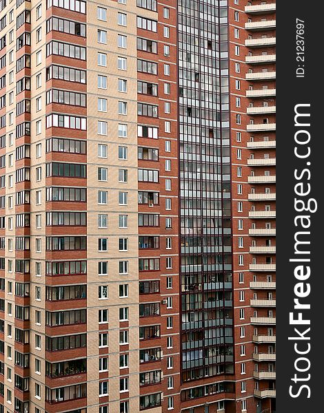 Multi-storey brick house with windows and balconies