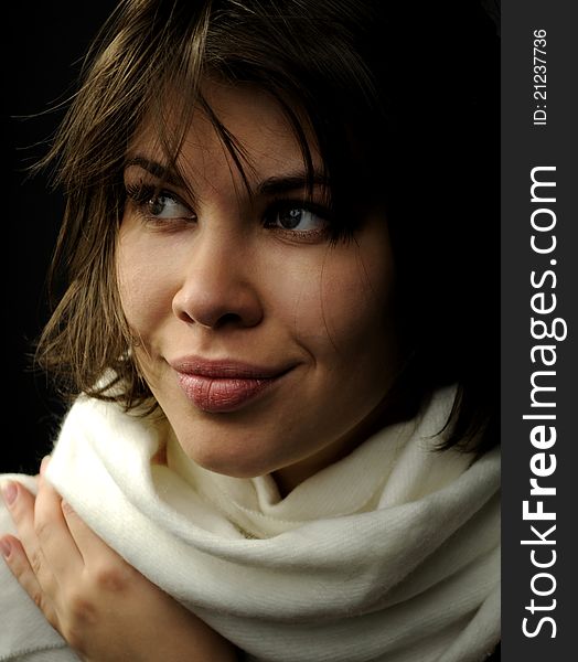 Smiling woman in black background wearing white scarf. Smiling woman in black background wearing white scarf