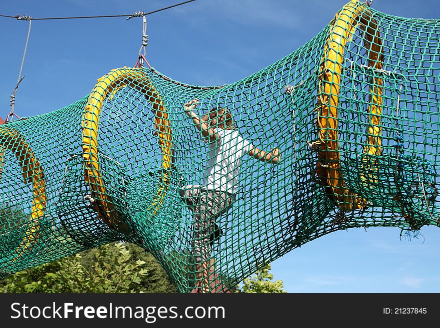 The child passes through the mesh. Playground