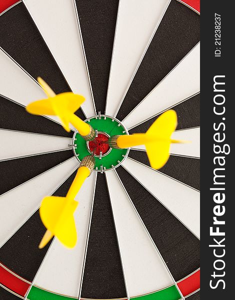 Dart hitting the bullseye on a dartboard. Dart hitting the bullseye on a dartboard