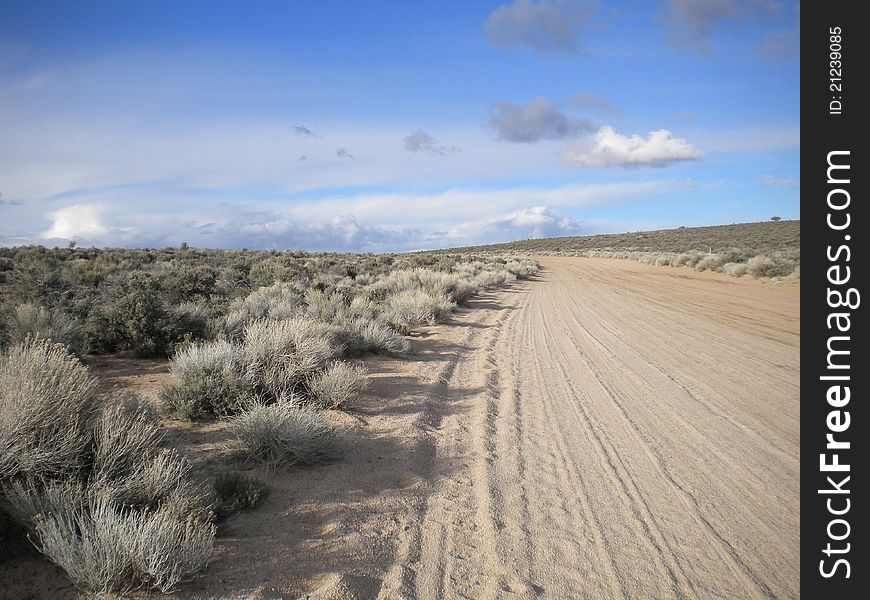 A sandy turn on a lonely desert road in winter