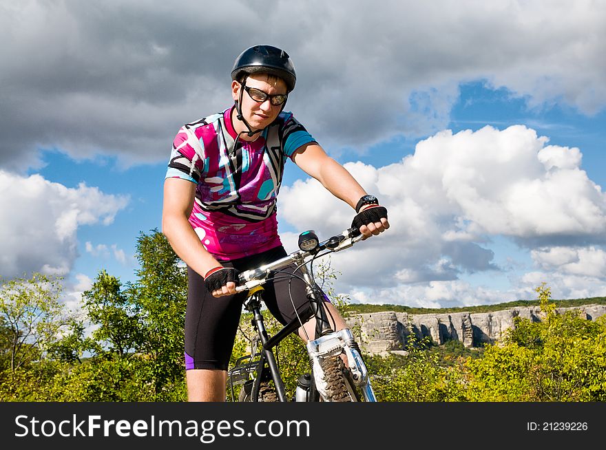 Young sportive man with his black muontain-bike. Young sportive man with his black muontain-bike