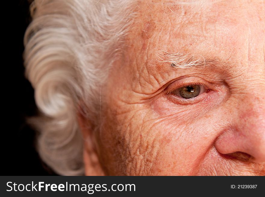 Portrait of a senior woman on a black background.