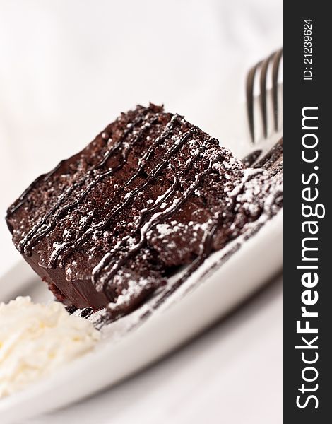 Slice of chocolate cake dessert on a white plate