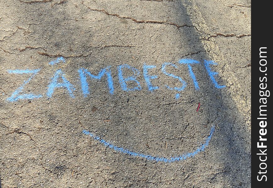 Smile on the tarmac in Romanian language "zambeste" meaning smile, Smile more. Smile on the tarmac in Romanian language "zambeste" meaning smile, Smile more