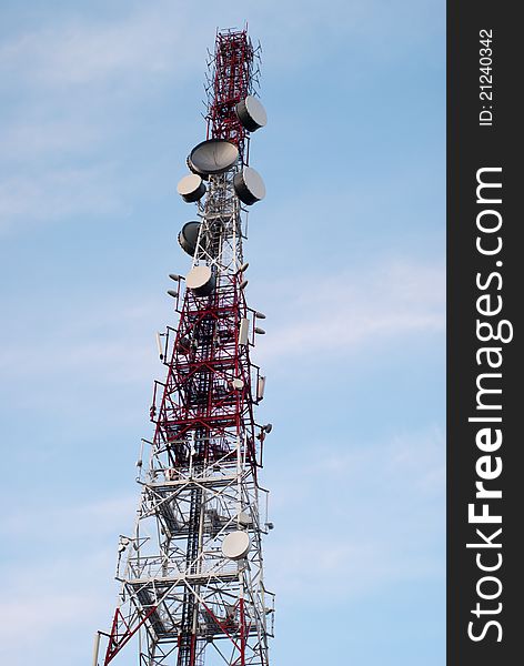 Big red & white antenna on blue sky. Big red & white antenna on blue sky