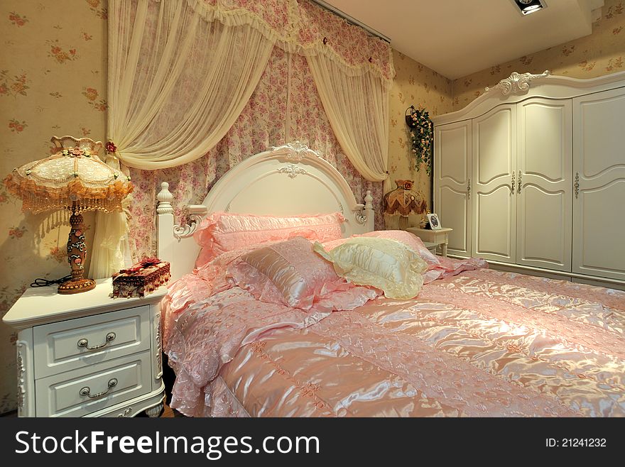 Flowery and pink color bedding and furniture in bedroom, elegance and fine style for female. Flowery and pink color bedding and furniture in bedroom, elegance and fine style for female.