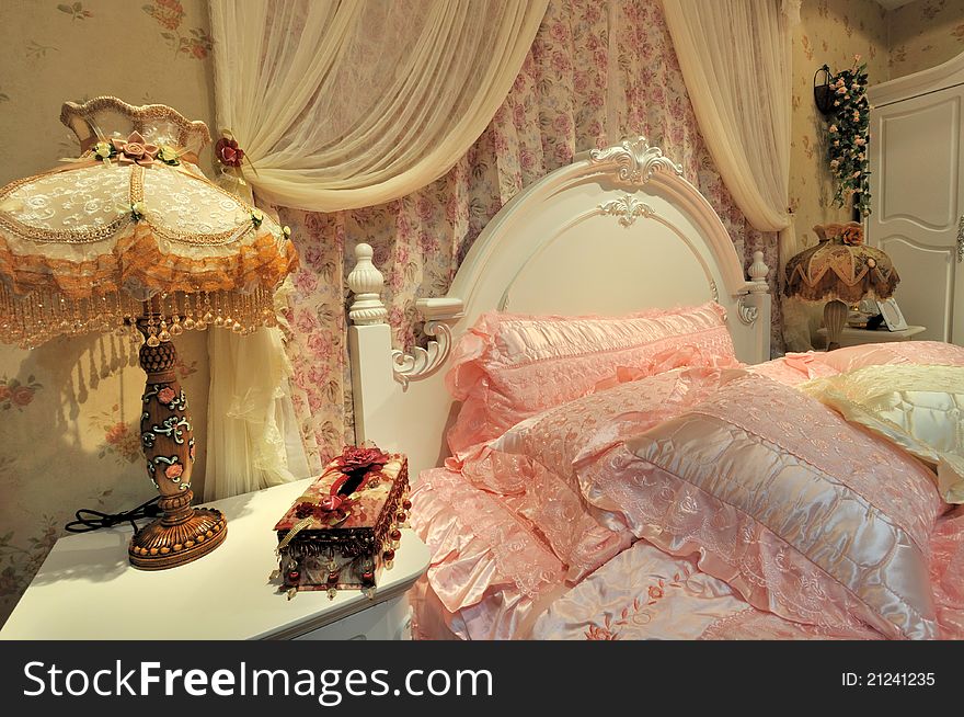 Flowery and pink color bedding and furniture in bedroom, elegance and fine style for female. Flowery and pink color bedding and furniture in bedroom, elegance and fine style for female.