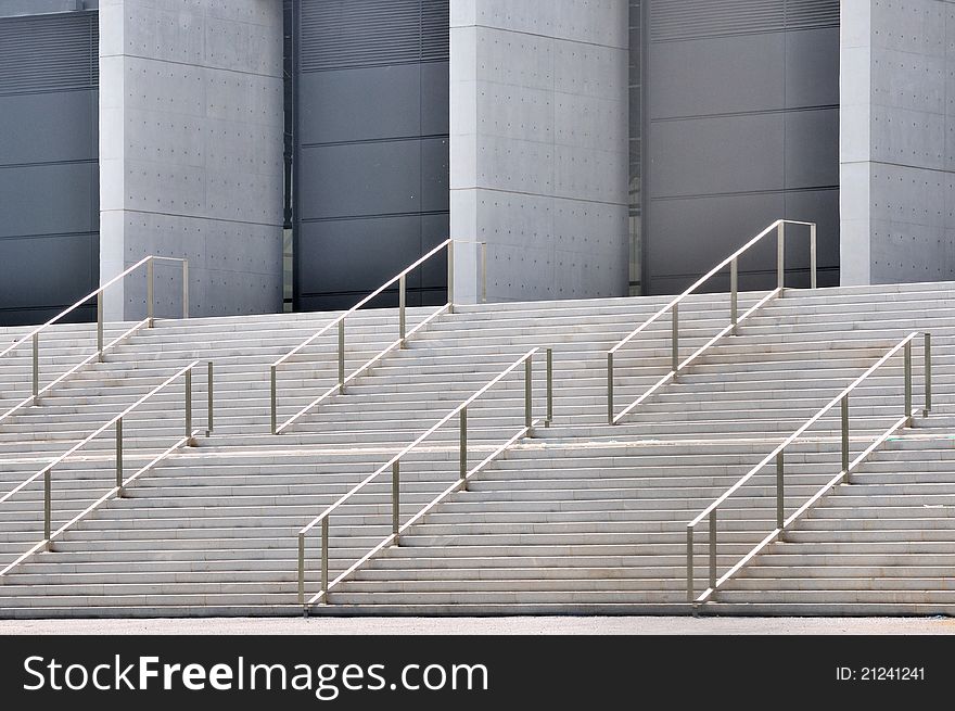 Concrete platform stage with metal handrail in repeated pattern and design, shown as industrial architecture or featured pattern and texture. Concrete platform stage with metal handrail in repeated pattern and design, shown as industrial architecture or featured pattern and texture.