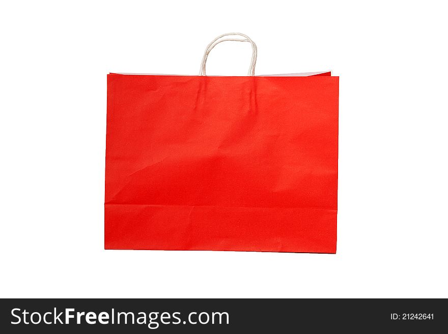 A red shopping bag on white isolated background. A red shopping bag on white isolated background.