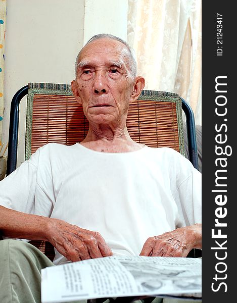 The Old Serious Chinese people who Sitting in Chair. The Old Serious Chinese people who Sitting in Chair