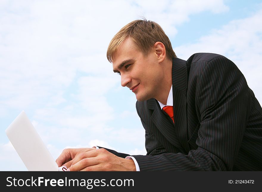 Portrait of profile of confident businessman with laptop
